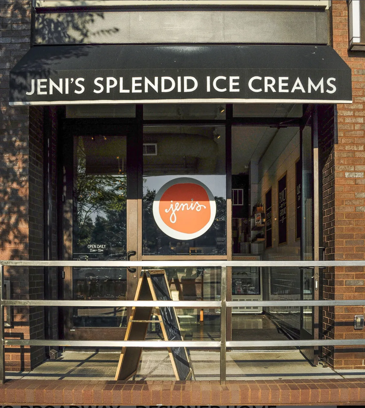 A cheerful ice cream shop storefront with a welcoming sign, menu board, and entrance door. The vibrant scene suggests a fun neighborhood hangout for families and small groups to enjoy a sweet treat together.