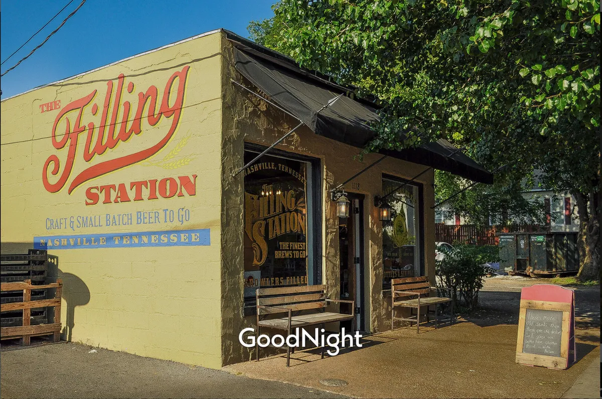 An exterior view of The Filling Station with its welcoming sign, entrance, and outdoor seating area, where people enjoy craft beer and the laid-back ambiance of the neighborhood.